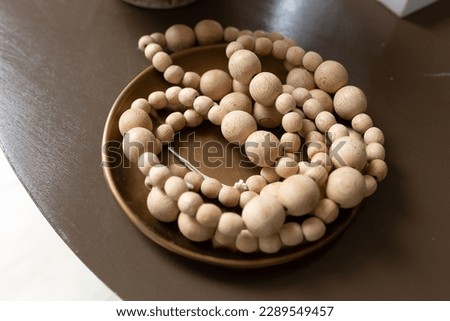 Close-up of baby natural wood beads in a dish