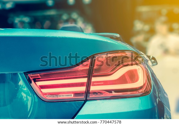 The Closeup Back Red Tail light car\
Convertible in Motor Show with Light\
Yellow