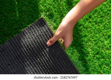 Close-up of the back of a roll of artificial turf. Synthetic artificial grass material easy to install and maintain - Shutterstock ID 2182767697