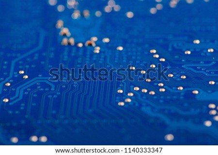 Closeup of back side of a blue electrical board