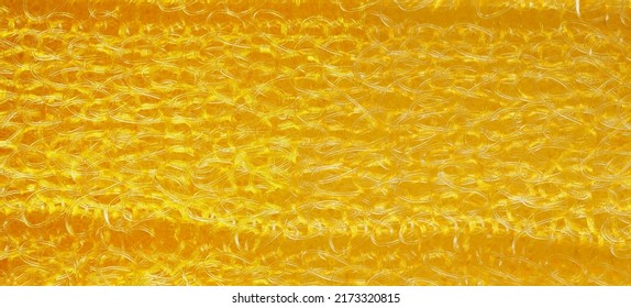 closeup, background, texture, large long horizontal banner. heterogeneous surface structure bright saturated yellow sponge for washing dishes, kitchen, bath. full depth of field. high resolution photo - Shutterstock ID 2173320815