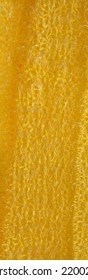 closeup, background, texture, large long vertical banner. heterogeneous surface structure bright saturated yellow sponge for washing dishes, kitchen, bath. full depth of field. high resolution photo - Shutterstock ID 2200208489