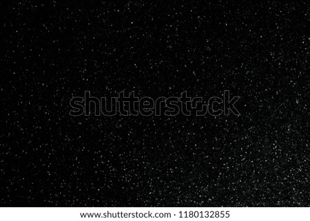 closeup background texture of snowflakes during a snowfall on a black background