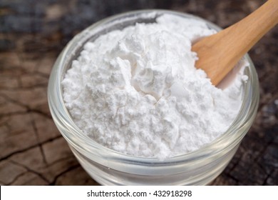 Closeup Baking Powder On Wooden Background 