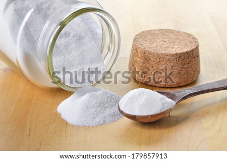 Close-up of baking soda in a glass jar. Bicarbonate of soda.