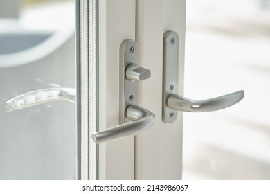 Close-up Of Balcony Doors With Two Silver Handles And Double Glazed Windows