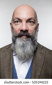 Closeup Of A Bald Man With Long Beard, Isolated On Gray