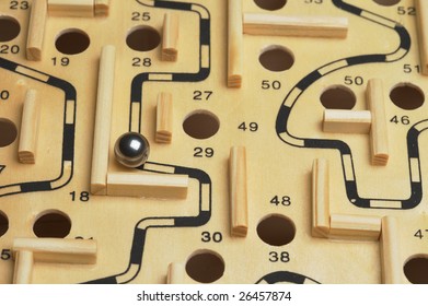 A Closeup Of A Ball Bearing Navigating A Wooden Maze