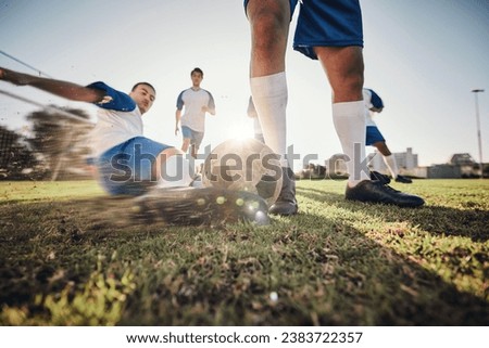 Closeup, ball and soccer with men, tackle and exercise with sports, competition and training. Zoom, football and healthy athletes with energy, fitness and teamwork for a match, action and blur motion