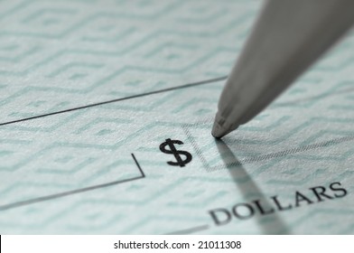 Closeup Of Ballpoint Pen Writing On A Blank Bank Check, Ready To Fill In The Dollar Amount; Selective Focus On The Tip Of The Pen, Very Shallow DOF