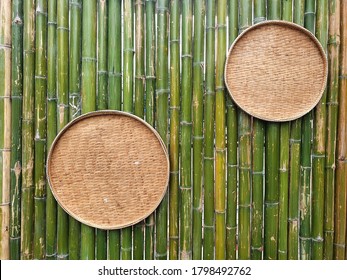 Closeup of Bamboo threshing basket hanging on the bamboo wall background, Thai traditional kitchenware concept at Thailand. - Powered by Shutterstock