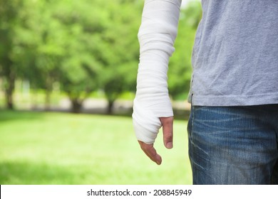 Closeup Of Bandaged Arm  With Park Background