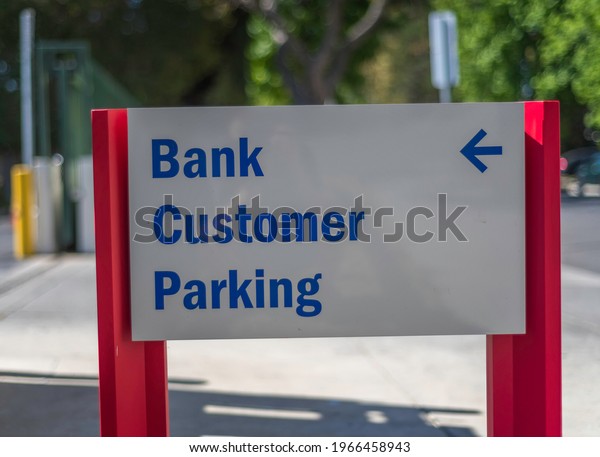 Close-up of a bank\
customer parking sign.