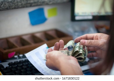 Closeup Of Bank Teller Counting Money