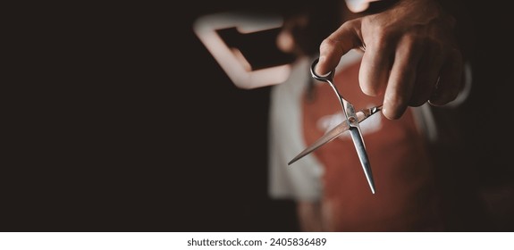 Closeup barber hold with scissors around chair. Vintage old barbershop banner, hairdresser salon for man, warm toning. - Powered by Shutterstock