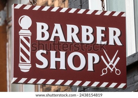 Close-up of a Barber Shop sign.