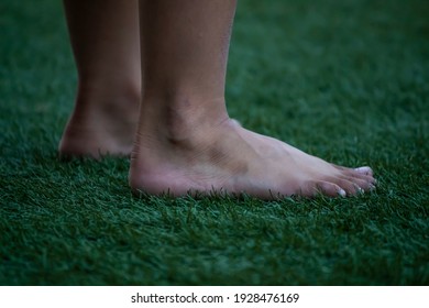 Closeup Barefoot kid on the artificial grass - Powered by Shutterstock