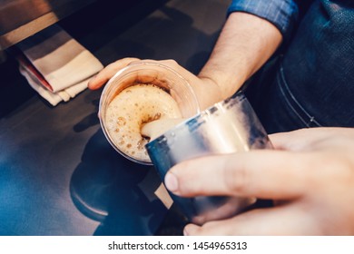 Closeup Of Barista Hands Making Cold Iced Coffee Cappuccino Latte. Waiter Server Pouring Drink In Plastic Transparent Cup. Small Business And Person At Work Concept.