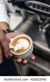 Closeup Of Barista Pouring Milk Into Art Cappuccino