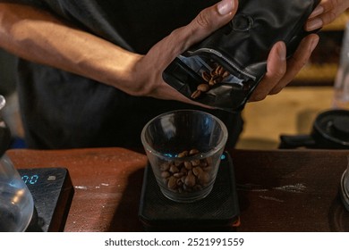 Close-up of a barista preparing coffee beans in a kitchen setting, showcasing the process of measuring and grinding for a fresh brew. - Powered by Shutterstock