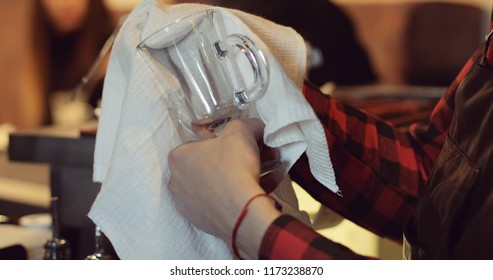 Close-up Of A Barman Wiping A Glass Cup With A White Towel. Expensive Restaurant Bar.