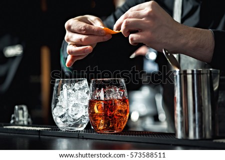 Similar – Image, Stock Photo Detail of a bartender opening a bottle of beer using a bottle opener at a bar counter.