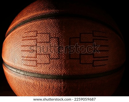 Closeup of a basketball with a tournament bracket design                              