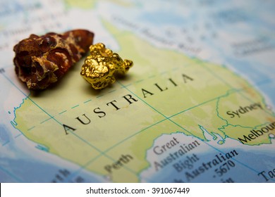 Close-up Of Bauxite Mineral And Gold Nugget On Top Of A Map Of Australia