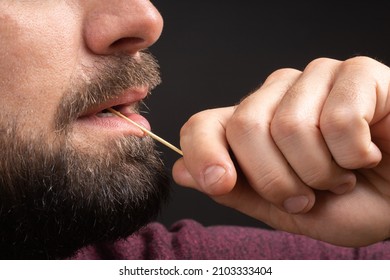 Closeup Bearded Man Clean Teeth From Food Stuck Teeth With Toothpick Eating. Rude Behavior. Uncultured And Impolite Habit