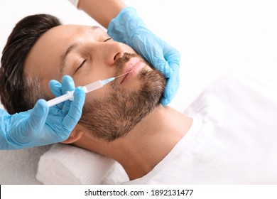 Closeup Of Bearded Man Getting Nasolabial Injection At Aesthetic Clinic, Copy Space. Plastic Surgeon Injecting Anti-aging Filler In Handsome Man Face. Male Cosmetology, Aesthetic Medicine Concept