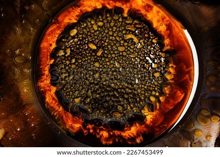 Close-up of beautiful abstract patterns created with ferromagnetic liquid and other chemical agents.