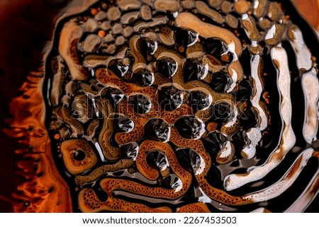Close-up of beautiful abstract patterns created with ferromagnetic liquid and other chemical agents.