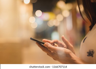 Closeup Of  Beautiful Asia Woman Using Smartphone,mobile Phone Working,relax ,fun And Happy  In The City On Holiday,bokeh Background.