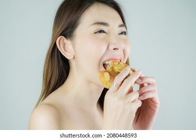 Close-up beautiful asian woman enjoy eating a cake. isolated on white background.