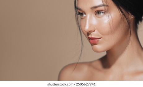 Close-up of a beautiful Asian woman with glowing skin, posing in a studio setting. Ideal for beauty, skincare, and cosmetics advertisements. High quality image for conceptual and promotional use. - Powered by Shutterstock