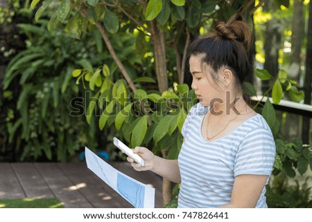 Close-up beautiful asian woman hold smart phone and table paper check business finance, email, massage, status 