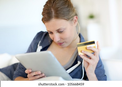 Closeup of beautiful blond girl doing online shopping