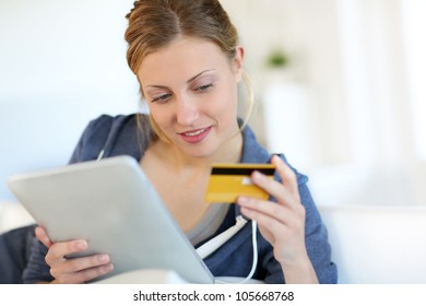 Closeup of beautiful blond girl doing online shopping