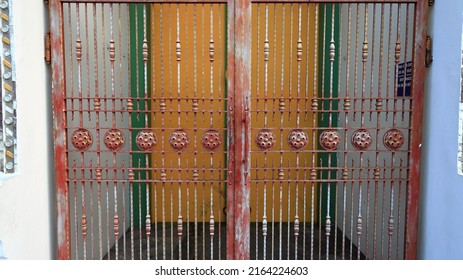 Close-up beautiful detail of traditional Thai art at Ancient Temple gate, decorated made from metal and ceramic tile on the  building wall of public Buddhist temple ,textures background
