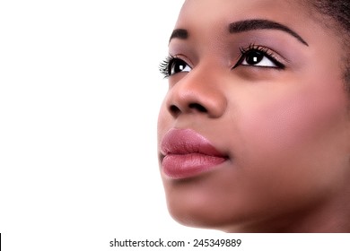 Closeup Of Beautiful Determined African Black Woman In Make Up And Eyes Looking Up To Future Dreams Isolated On White With Copy Space