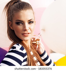 Close-up Of Beautiful Girl With Smokey Eye Make Up, Ponytail Hair In Black And White Striped Dress With Bunch Of Multicolored Balloons