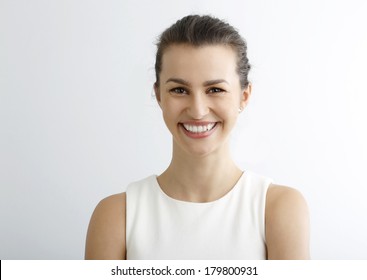 Close-up Of Beautiful Happy Woman Looking At Camera Against White Background.