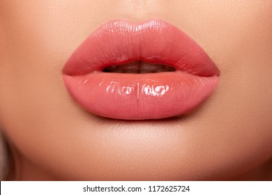 Close-up Beautiful lips. Part of face, young woman close up. Sexy plump lips Nude lipstick. peach color of lipstick on large lips. close-up. - Image   