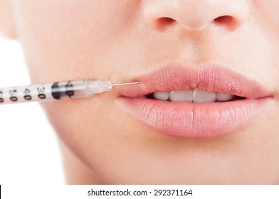 Closeup of beautiful mouth and lips with botox and syringe