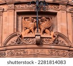 Close-up of beautiful sculpted winged lions on the facade of the building at 193 Fleet Street in London, UK.