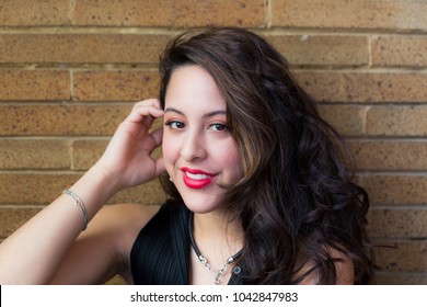 Closeup Of Beautiful Smiling Hispanic Brunette Young Woman With Long Curly Hair And Luscious Red Lips