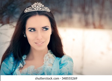 Close-up of Beautiful Snow Queen in Winter Decor - Portrait of a happy beautiful Renaissance queen in blue royal dress
 - Powered by Shutterstock