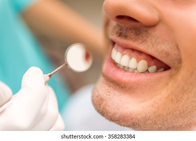 Close-up. Beautiful White Teeth Man On A Review Of The Dantist