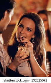 Closeup Of A Beautiful Woman At The Bar Talking With A Guy