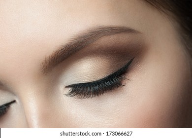 Closeup of beautiful woman eye with makeup, closed eyes
